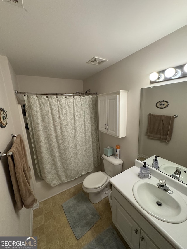 full bathroom featuring vanity, shower / bath combination with curtain, and toilet