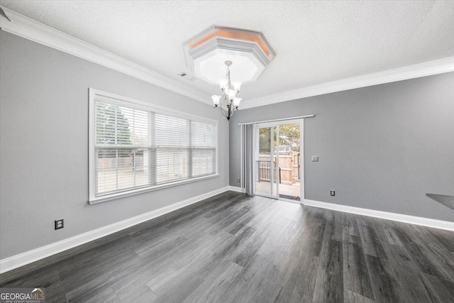 empty room with dark hardwood / wood-style flooring, a textured ceiling, an inviting chandelier, and crown molding