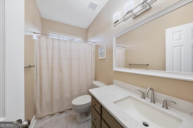 bathroom featuring tile patterned floors, a shower with curtain, vanity, and toilet