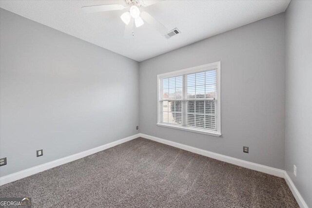 carpeted empty room featuring ceiling fan