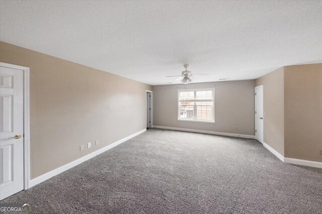 spare room with ceiling fan, carpet floors, and a textured ceiling