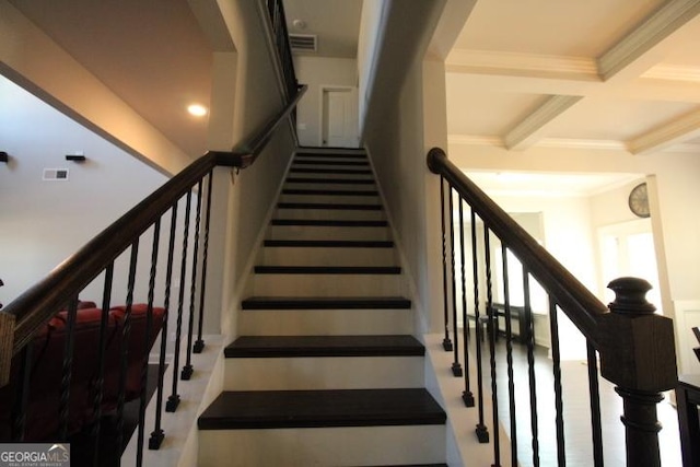 stairs featuring beamed ceiling, ornamental molding, and coffered ceiling