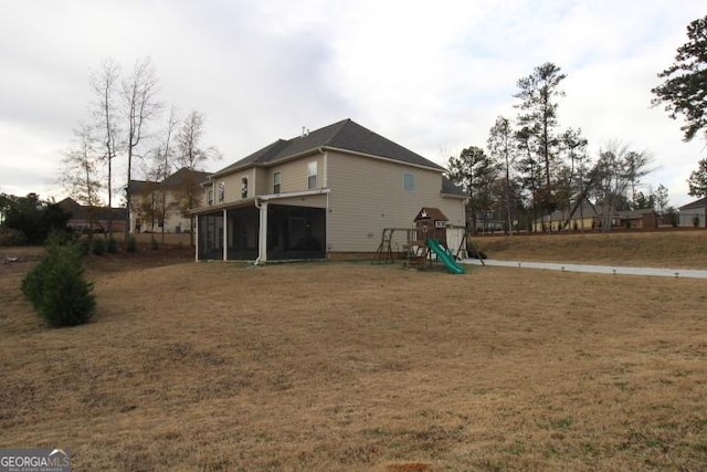 exterior space with a yard, a playground, and a sunroom