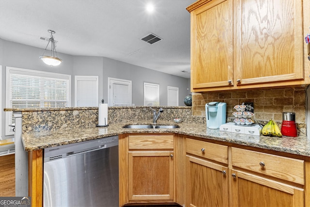 kitchen featuring dishwasher, sink, light stone counters, kitchen peninsula, and decorative backsplash