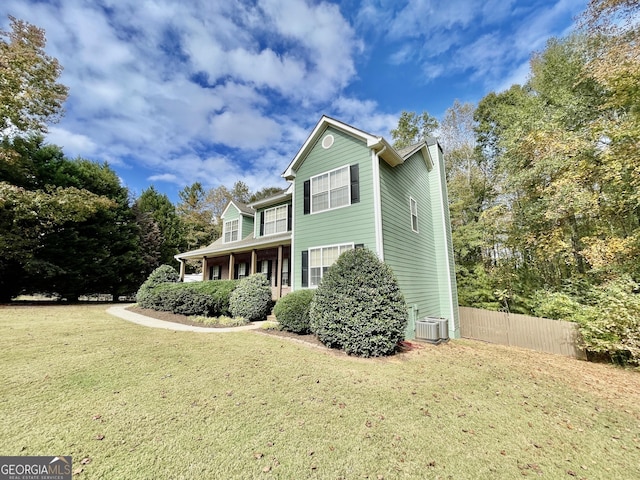 view of property exterior featuring a lawn and central air condition unit