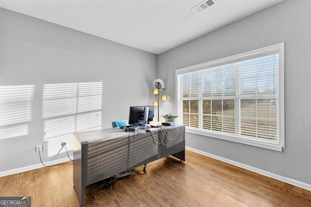 office area featuring hardwood / wood-style floors and a textured ceiling