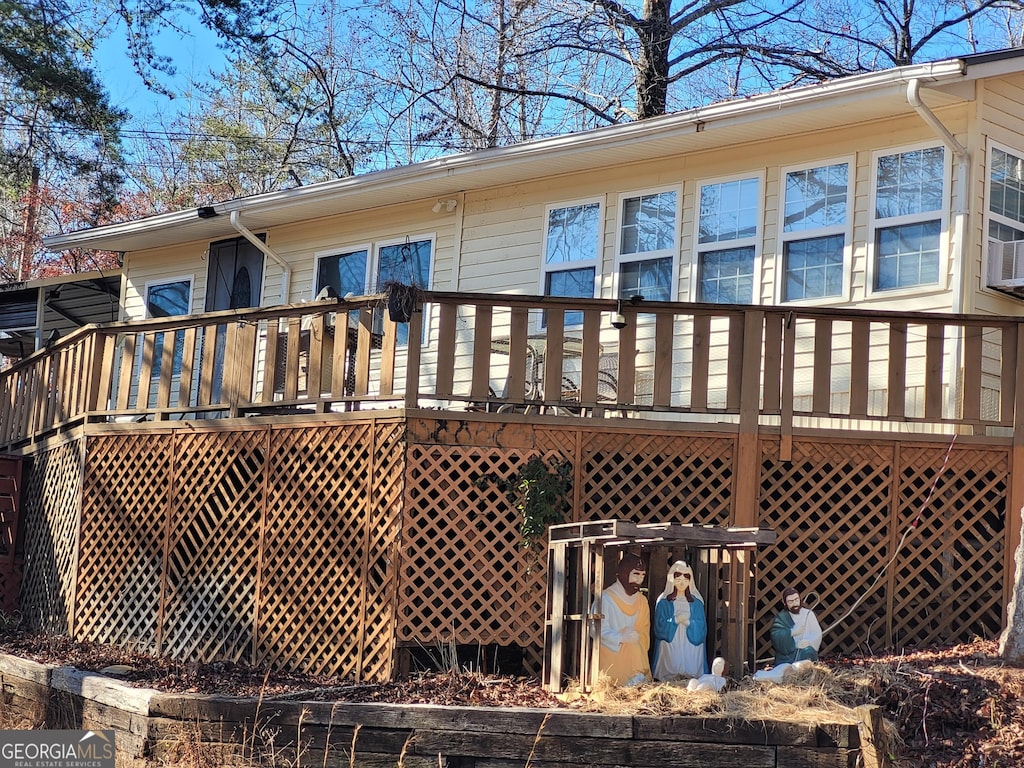 rear view of house with a wooden deck