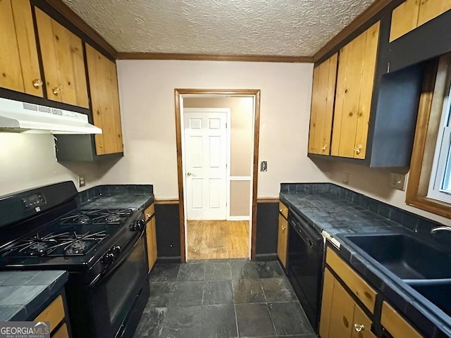 kitchen featuring sink, a textured ceiling, and black appliances