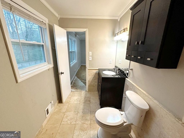 bathroom featuring ornamental molding, vanity, and toilet