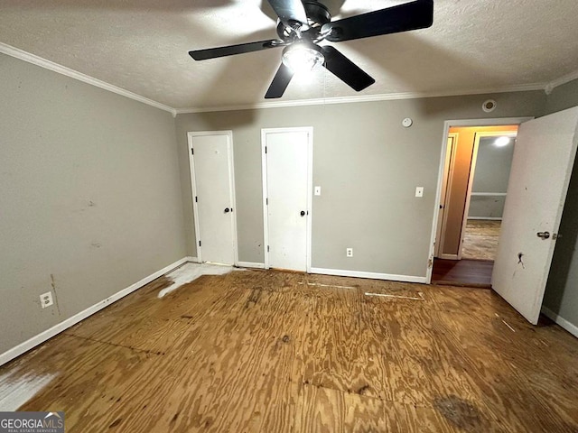 unfurnished bedroom with crown molding, ceiling fan, a textured ceiling, and hardwood / wood-style flooring