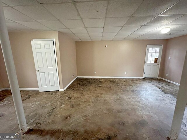 basement with a paneled ceiling