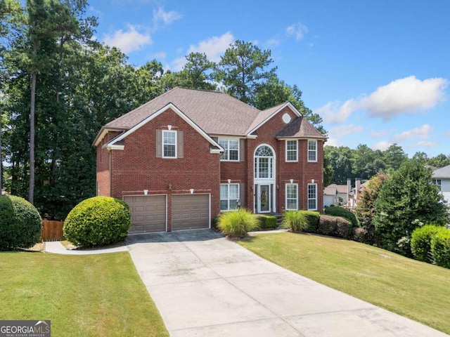 view of front of home featuring a garage and a front lawn