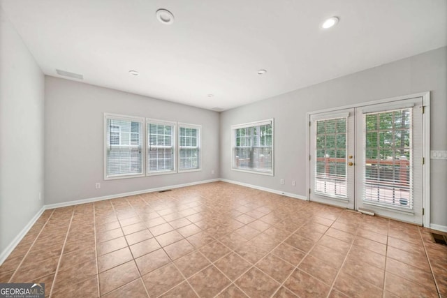 tiled spare room with french doors