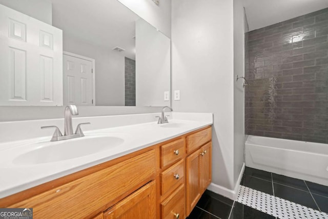 bathroom featuring tile patterned floors, vanity, and tiled shower / bath combo