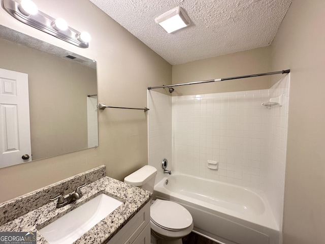 full bathroom featuring vanity, a textured ceiling, shower / bath combination, and toilet