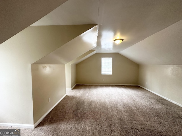 bonus room featuring carpet flooring and vaulted ceiling