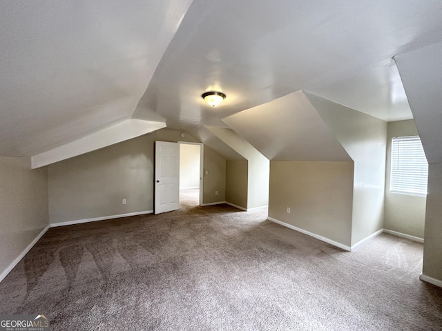 additional living space with carpet and vaulted ceiling