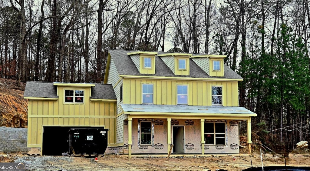 view of front of home featuring covered porch and a garage