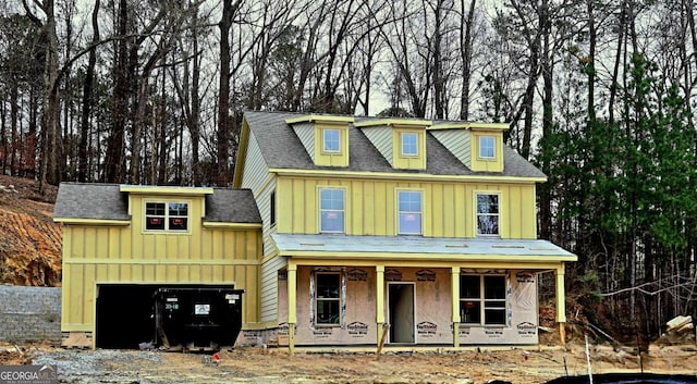 view of front of home featuring covered porch and a garage