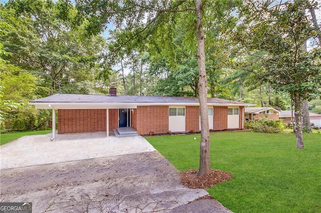 ranch-style house with a front yard and a carport