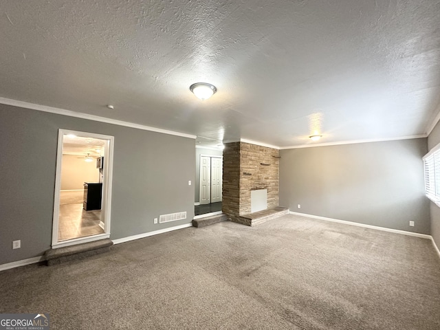 unfurnished living room featuring carpet, a textured ceiling, and ornamental molding