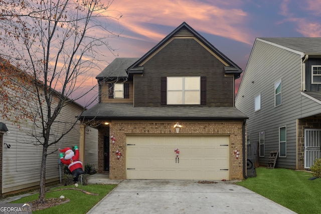 view of front of home featuring a yard and a garage