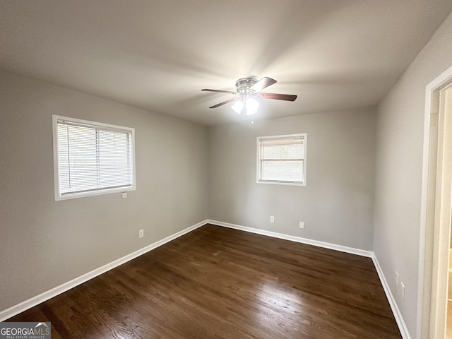 empty room with ceiling fan and dark wood-type flooring