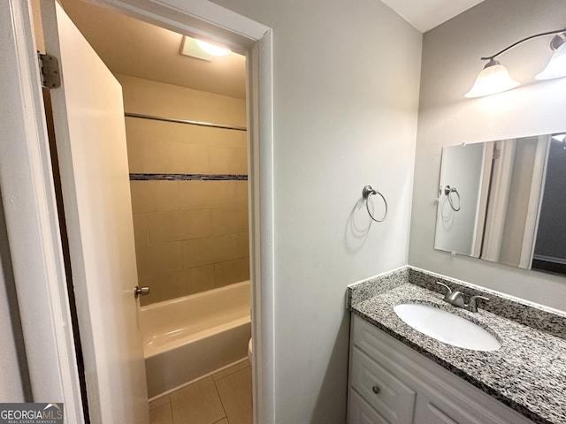 bathroom with tile patterned flooring, vanity, and tiled shower / bath combo