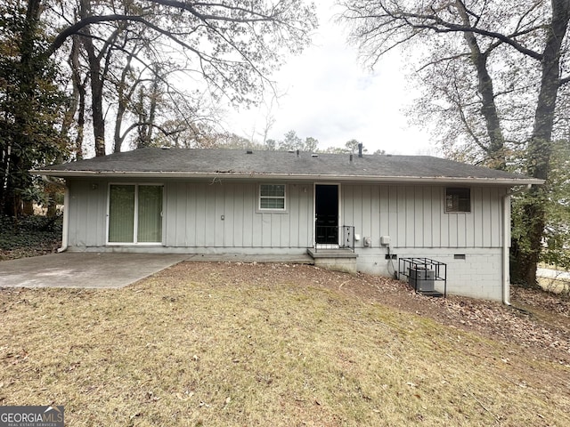 rear view of house with a lawn, a patio, and central AC