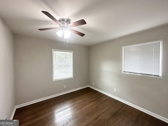 unfurnished room featuring dark hardwood / wood-style floors and ceiling fan