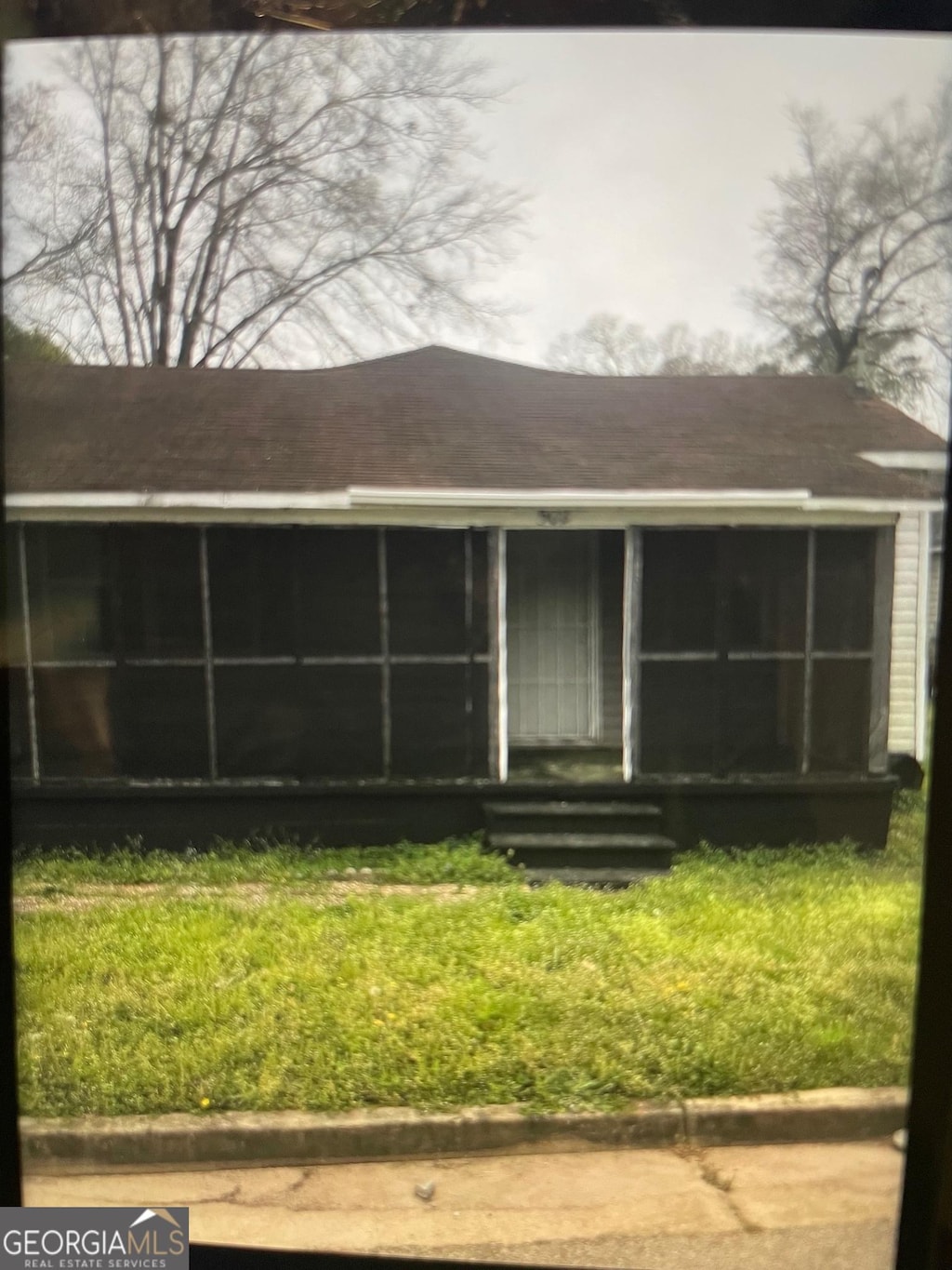 view of front of property with a sunroom