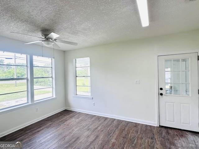 3039 Albany Ave, Waycross, GA 31503 - unfurnished room featuring dark wood finished floors, baseboards, plenty of natural light, a ceiling fan, and a textured ceiling