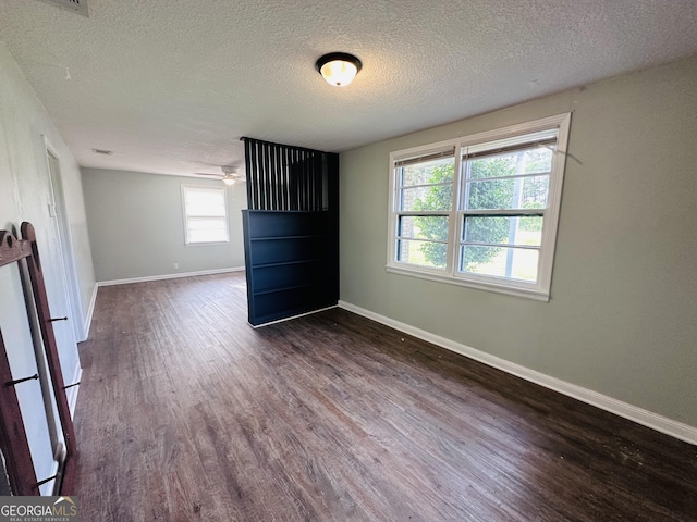 3039 Albany Ave, Waycross, GA 31503 - unfurnished room with dark wood-style flooring, a textured ceiling, baseboards, and ceiling fan