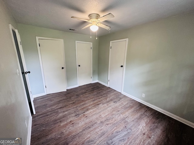 3039 Albany Ave, Waycross, GA 31503 - unfurnished bedroom featuring wood finished floors, baseboards, and a ceiling fan