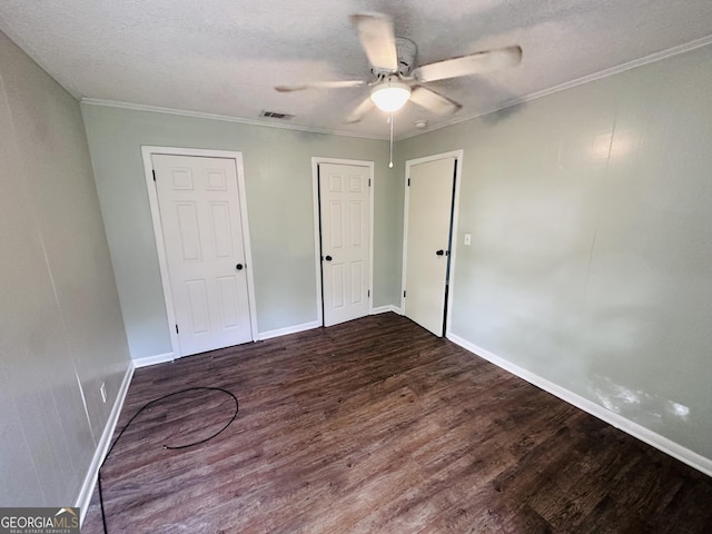 3039 Albany Ave, Waycross, GA 31503 - unfurnished bedroom with dark wood-style floors, a textured ceiling, baseboards, crown molding, and ceiling fan