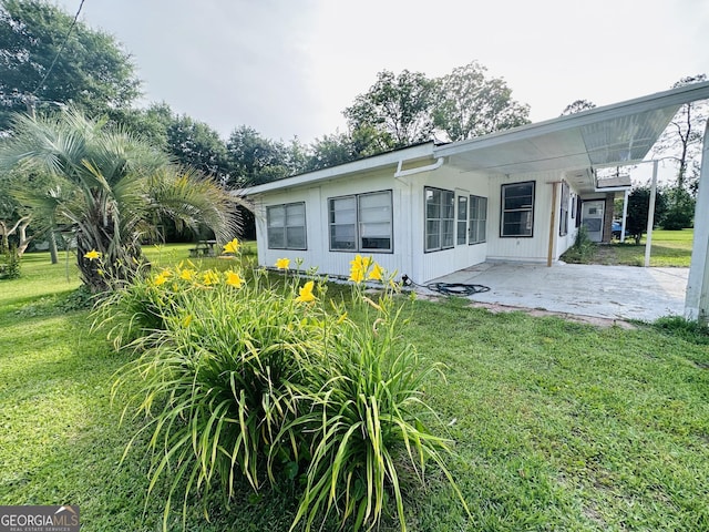 3039 Albany Ave, Waycross, GA 31503 - back of house with a patio area and a lawn