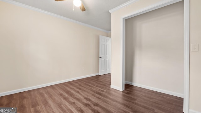 unfurnished bedroom with dark hardwood / wood-style floors, ceiling fan, ornamental molding, and a closet