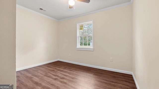 empty room featuring dark hardwood / wood-style floors, ceiling fan, and crown molding