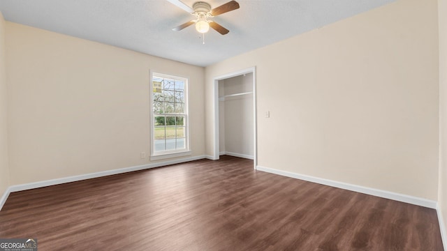 unfurnished bedroom featuring a textured ceiling, ceiling fan, a closet, and dark hardwood / wood-style floors