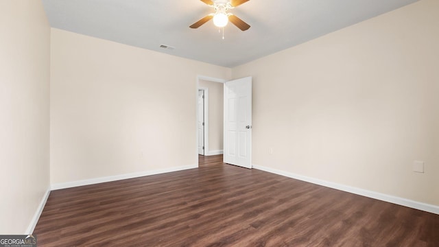 spare room featuring dark hardwood / wood-style floors and ceiling fan