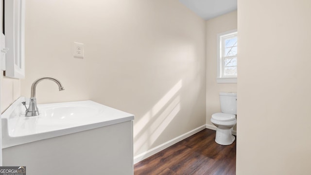 bathroom featuring hardwood / wood-style flooring, vanity, and toilet