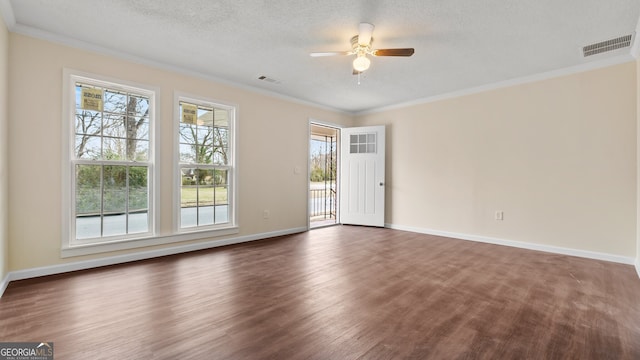 spare room featuring dark hardwood / wood-style floors, ceiling fan, crown molding, and a textured ceiling