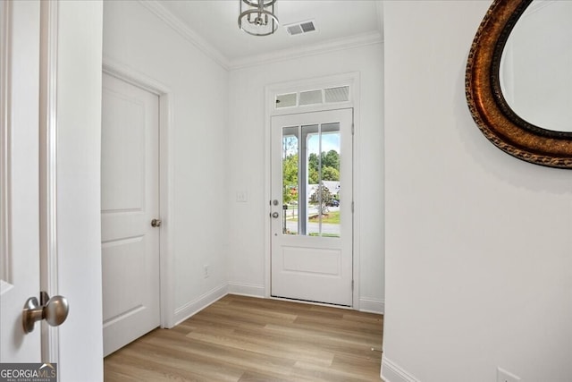 doorway to outside with light hardwood / wood-style floors and crown molding