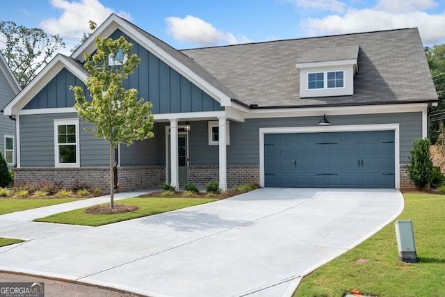 craftsman inspired home featuring a front yard and a garage