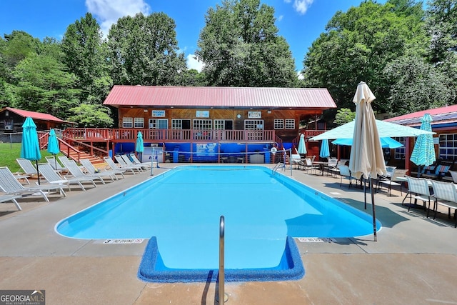 view of swimming pool with a patio