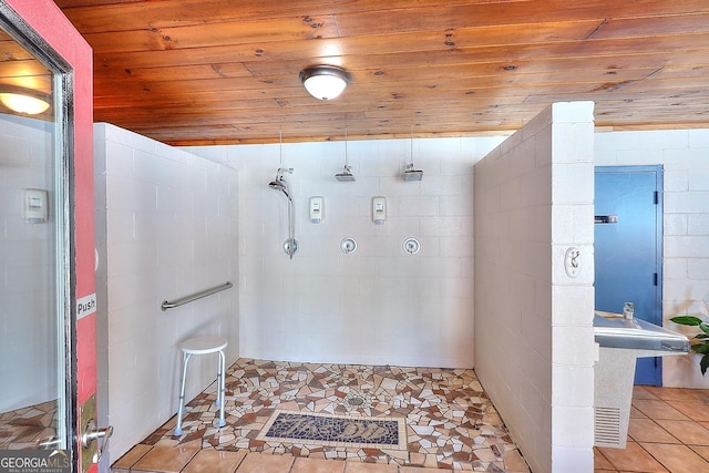 bathroom featuring tile patterned floors, a shower, and wooden ceiling