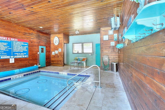 view of swimming pool with an indoor hot tub