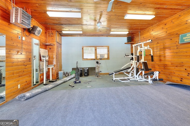 workout room featuring carpet, cooling unit, wooden walls, and wood ceiling