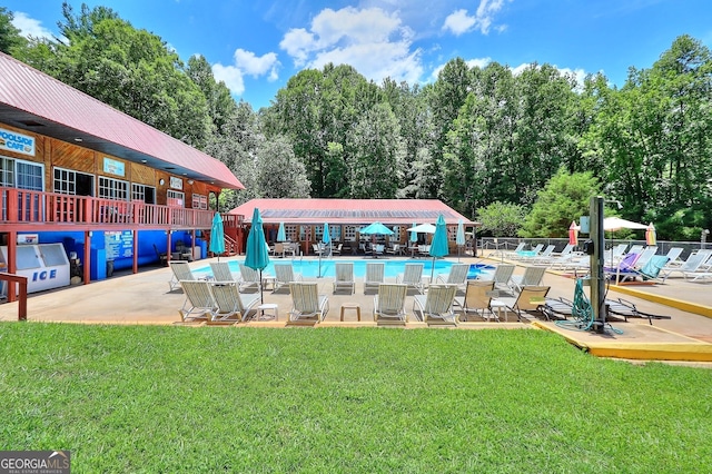 view of swimming pool with a patio and a lawn