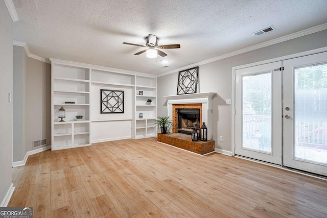 unfurnished living room with french doors, a textured ceiling, light hardwood / wood-style flooring, and plenty of natural light